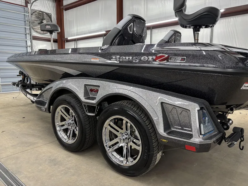 Slide: The Image of 2025 Ranger Z519R boat in a garage, showcasing sleek design and shiny wheels. - 7