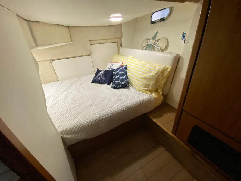 Slide: The Image of Cozy bedroom in 2001 Bayliner 3988 yacht with nautical decor and comfortable bedding. - 21