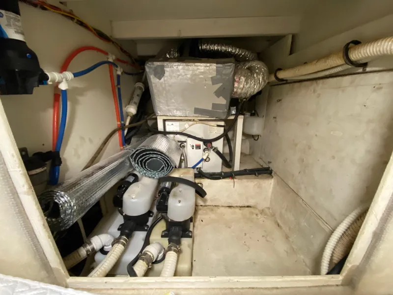 Slide: The Image of Engine room of 2001 Bayliner 3988 with visible pipes and equipment. - 24