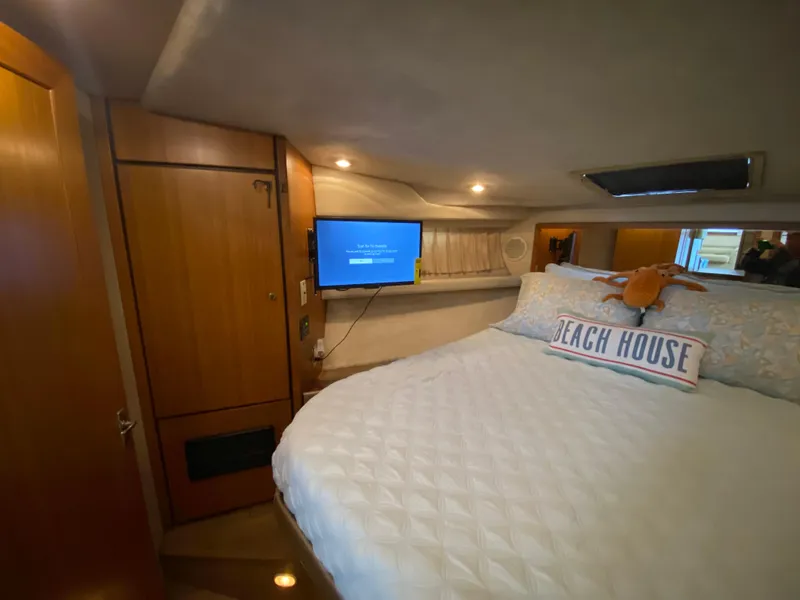 Slide: The Image of Cozy bedroom in 2001 Bayliner 3988 yacht with TV and "Beach House" pillow. - 28