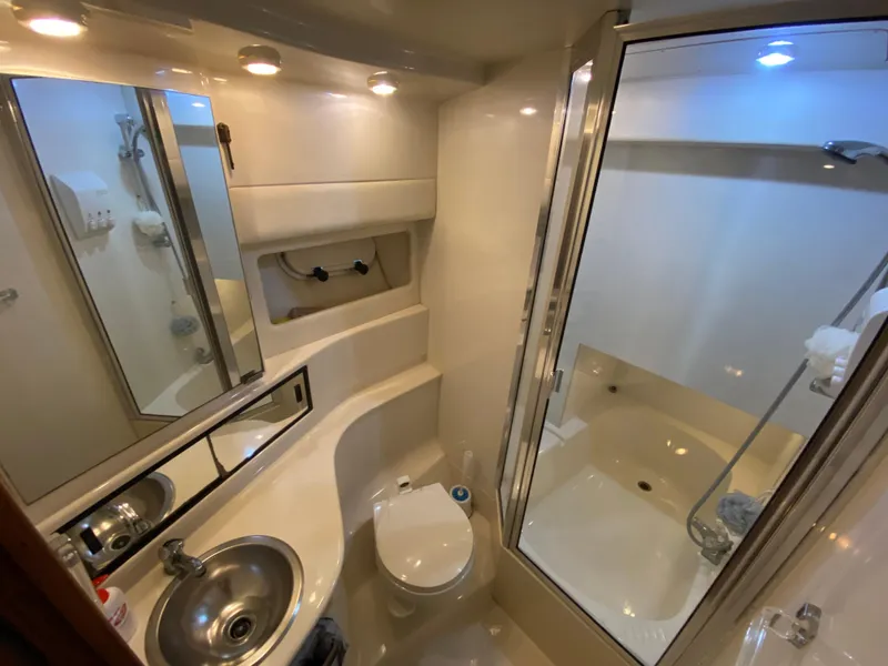 Slide: The Image of 2001 Bayliner 3988 yacht bathroom with shower, sink, and toilet. - 33