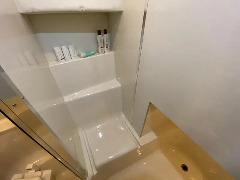 Slide: The Image of Bathroom interior of 2001 Bayliner 3988 yacht with toiletries on shelf. - 35