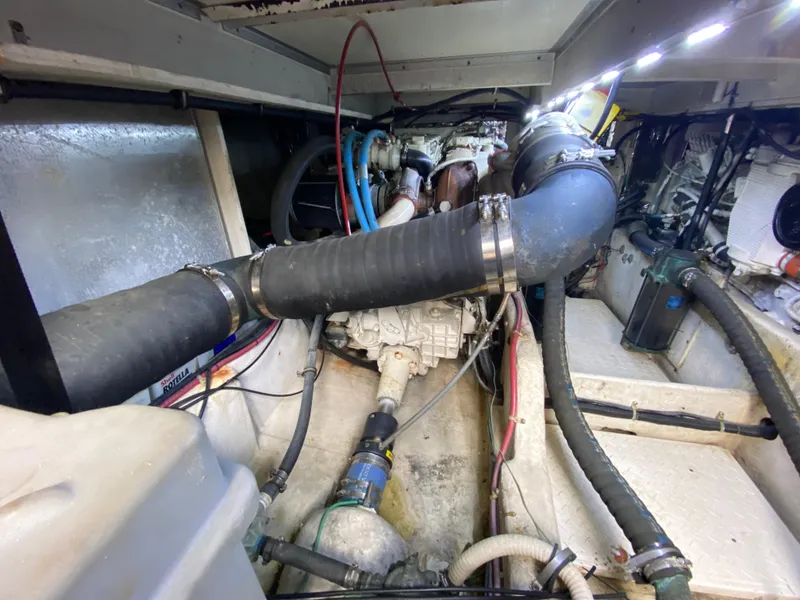 Slide: The Image of Engine room of a 2001 Bayliner 3988, showcasing hoses and mechanical components. - 37