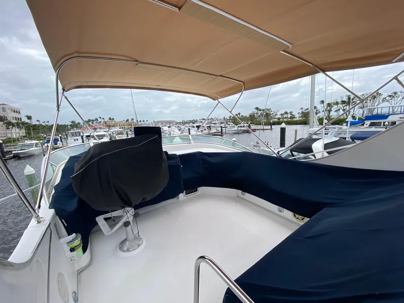 Slide: The Image of 2001 Bayliner 3988 yacht with covered seating area and canopy at marina. - 43