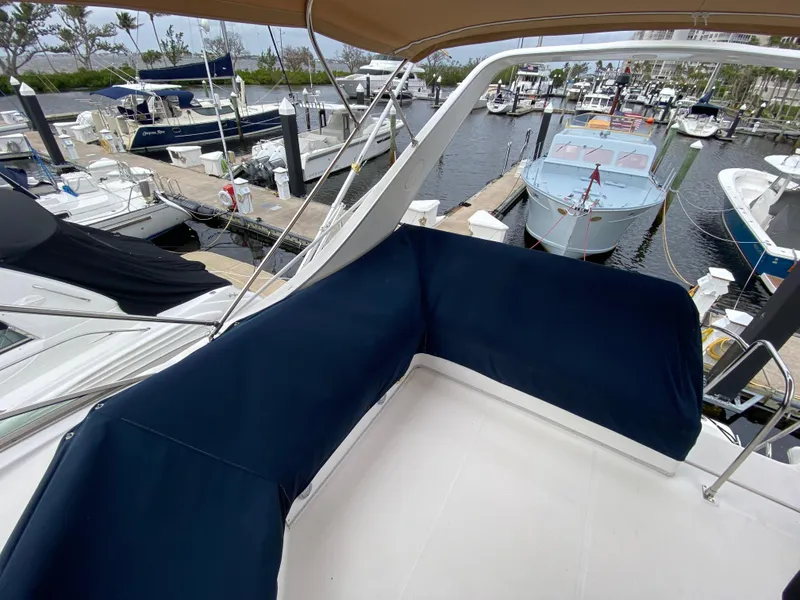 Slide: The Image of Bayliner 3988 (2001) yacht deck with blue seating, docked at marina. - 48