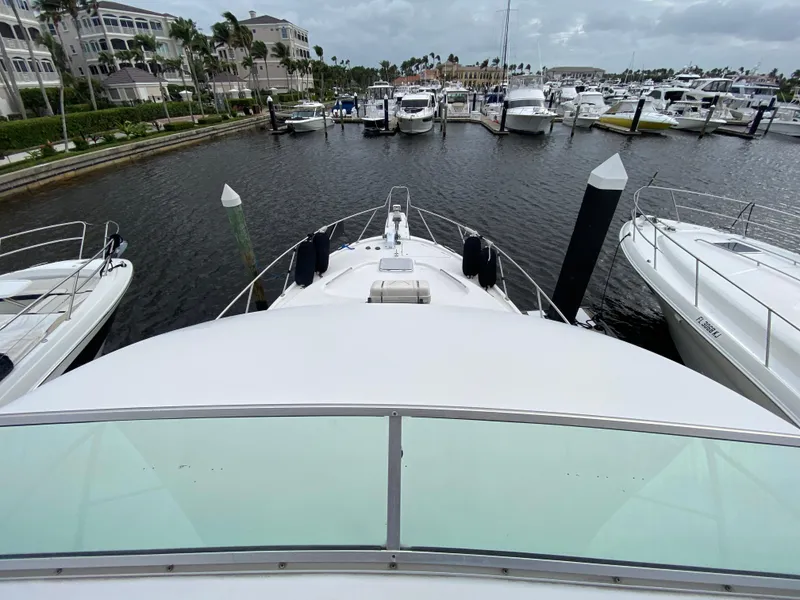 Slide: The Image of Bayliner 3988 (2001) yacht docked at marina, surrounded by other boats. - 49