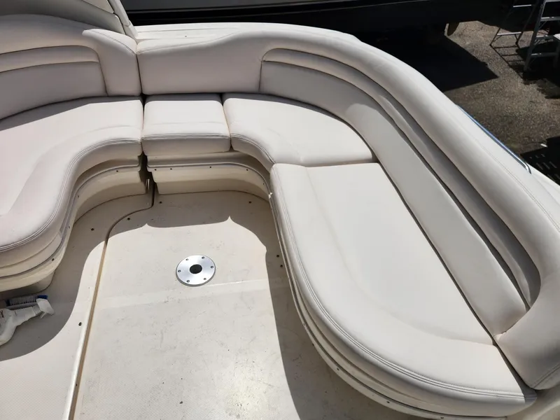 Slide: The Image of 2003 Sea Ray 340 Sundancer boat interior with white cushioned seating. - 10