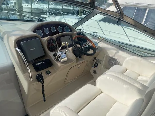 Slide: The Image of Helm of 2003 Sea Ray 340 Sundancer with steering wheel and navigation controls. - 12