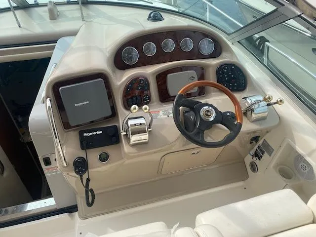 Slide: The Image of 2003 Sea Ray 340 Sundancer helm with steering wheel, gauges, and navigation equipment. - 15