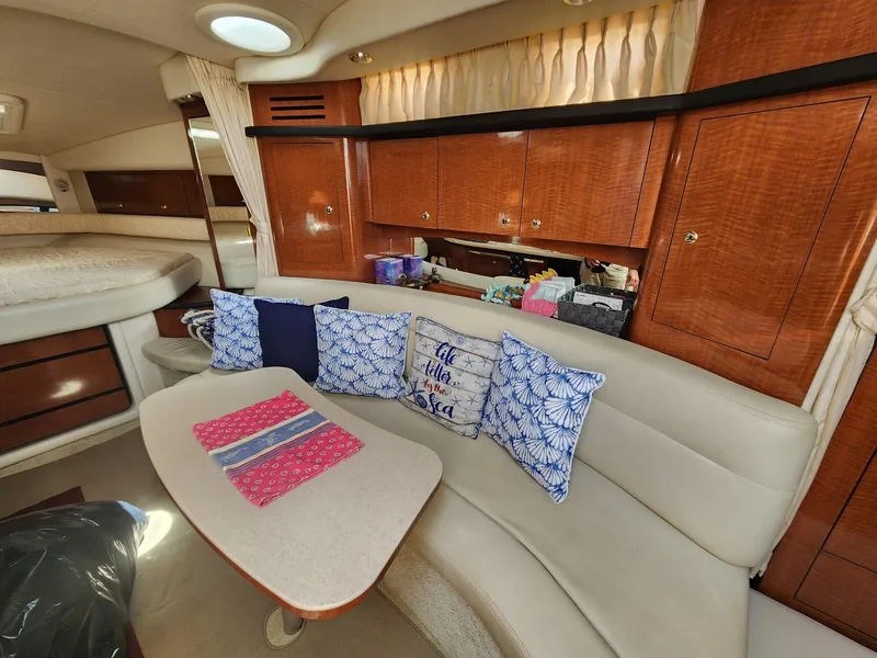 Slide: The Image of Interior of 2003 Sea Ray 340 Sundancer with cozy seating and decorative pillows. - 17