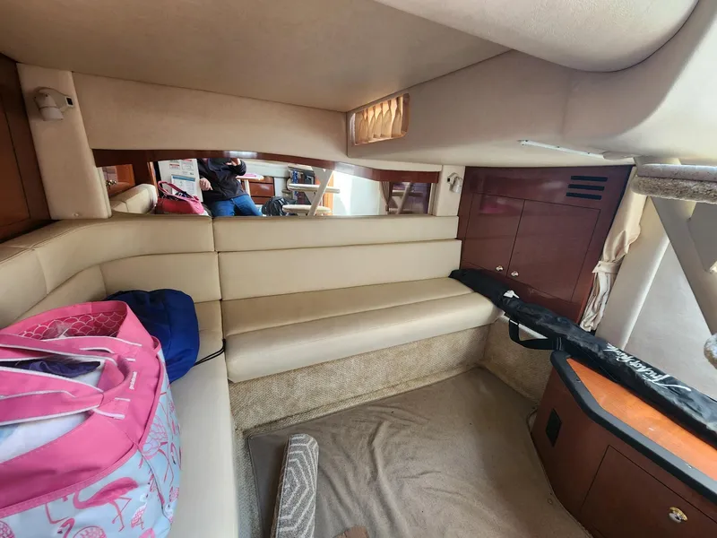 Slide: The Image of Interior of 2003 Sea Ray 340 Sundancer yacht with beige seating and storage. - 18