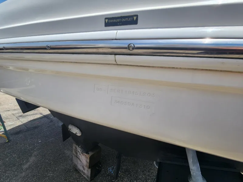 Slide: The Image of 2003 Sea Ray 340 Sundancer boat hull with visible exhaust outlet. - 3