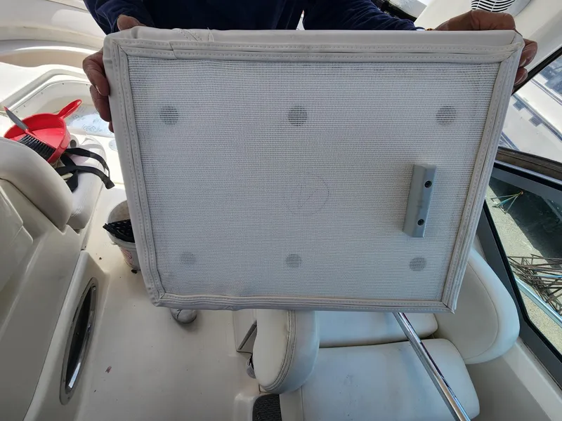 Slide: The Image of 2003 Sea Ray 340 Sundancer interior with a person holding a mesh panel. - 6