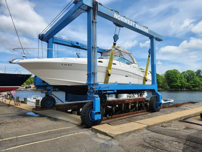 Slide: The Image of 2003 Sea Ray 340 Sundancer on a boat lift at Norwest Marine. - 7
