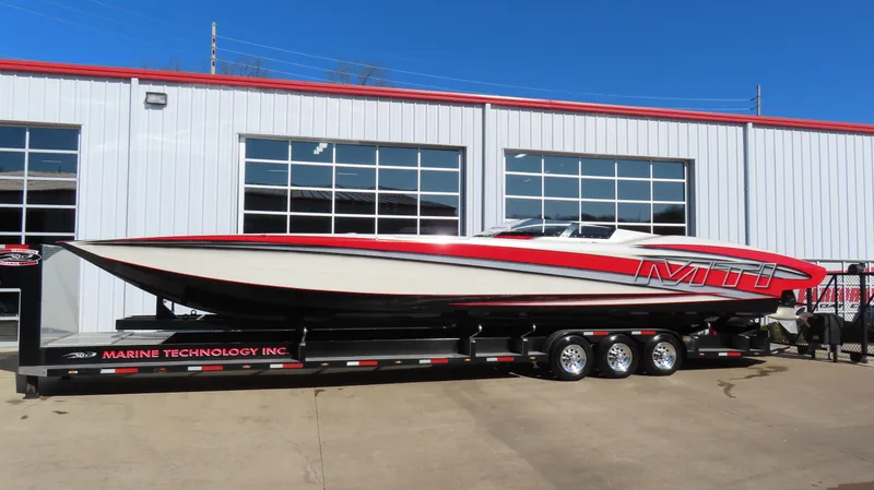 Slide: The Image of 2014 MTI 44 speedboat on trailer outside a garage. - 1