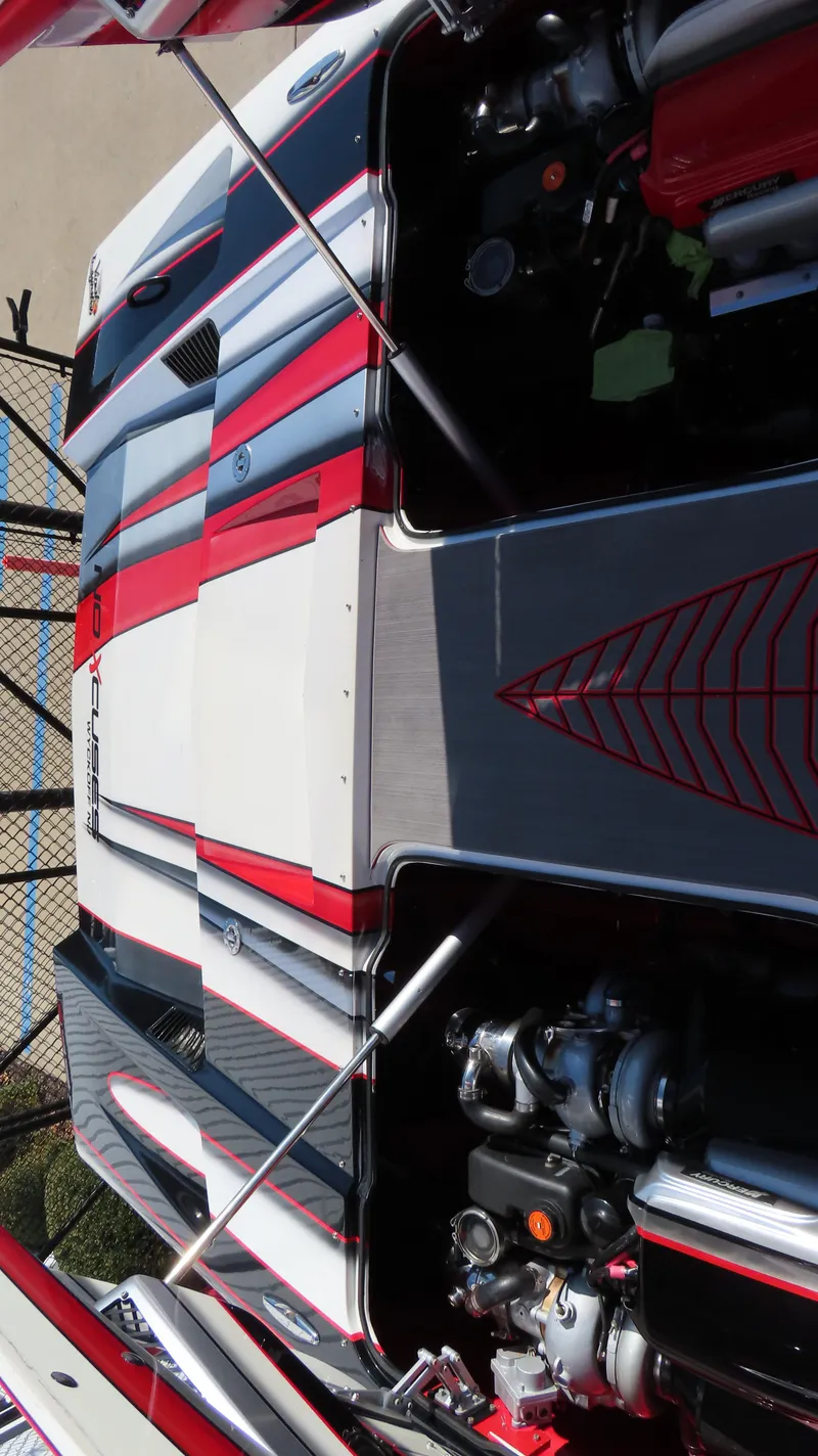 Slide: The Image of 2014 MTI 44 boat with red and white detailing, engine visible. - 10