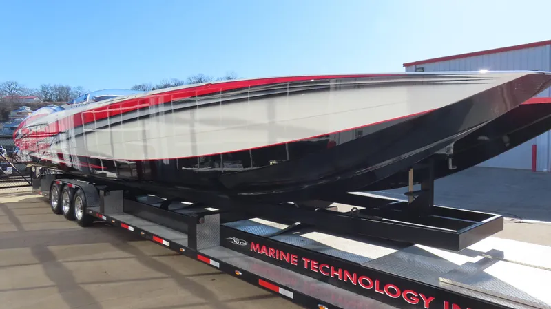 Slide: The Image of 2014 MTI 44 powerboat on trailer, sleek design with red and black accents. - 15