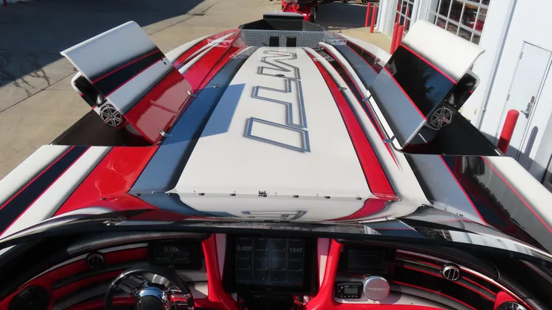 Slide: The Image of 2014 MTI 44 boat with sleek red and white design, featuring advanced dashboard controls. - 22