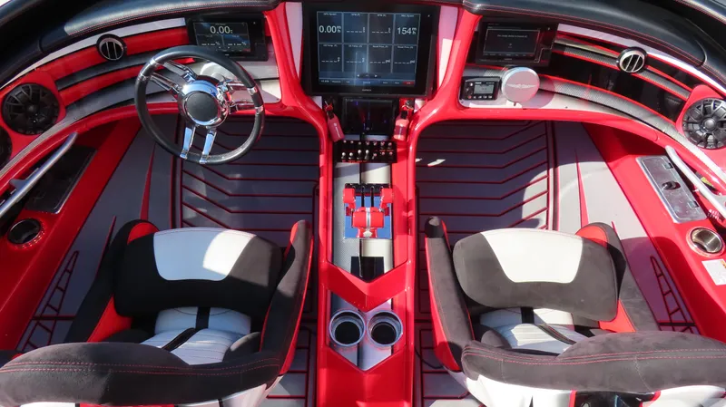 Slide: The Image of Luxurious MTI 44 boat interior, 2014 model, featuring red and black seating and advanced dashboard controls. - 23