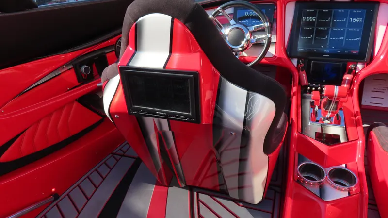 Slide: The Image of Red and black MTI 44 boat interior with modern dashboard and seating, 2014 model. - 24