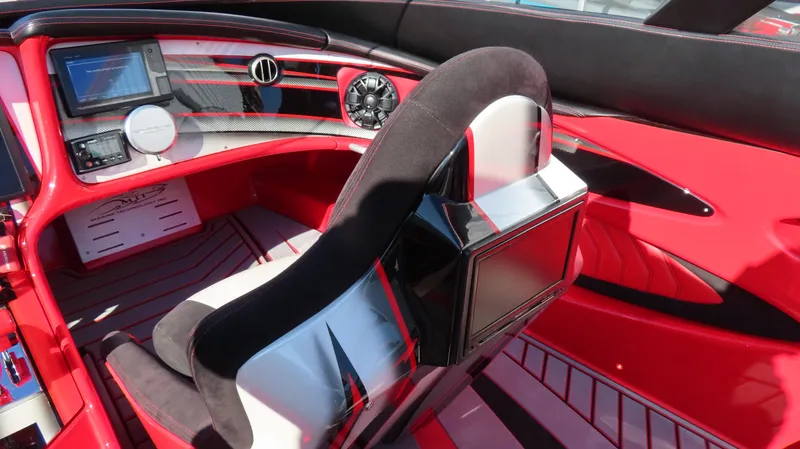 Slide: The Image of Interior of a 2014 MTI 44 boat, featuring a sleek red and black design. - 27