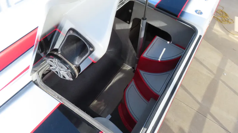 Slide: The Image of 2014 MTI 44 boat interior with red and gray seating and speaker system. - 28