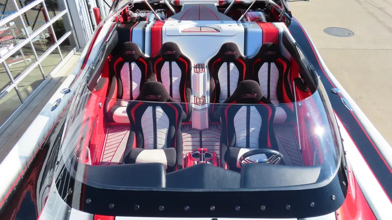 Slide: The Image of 2014 MTI 44 boat interior with red and black seating, sleek design, and modern dashboard. - 35