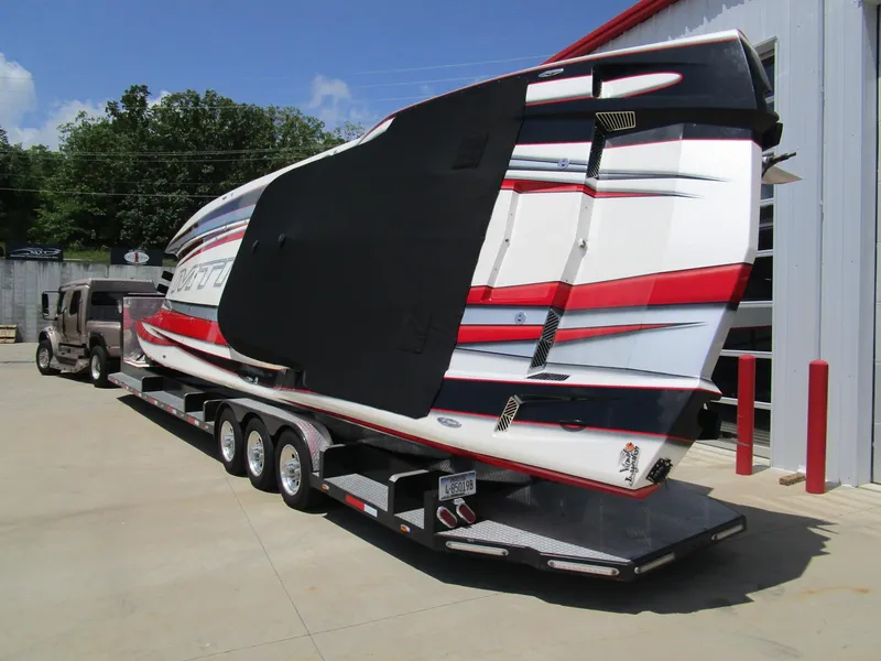 Slide: The Image of 2014 MTI 44 boat on trailer, featuring sleek design and vibrant red, white, and black colors. - 9