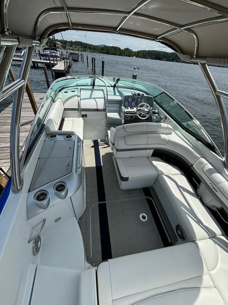 Slide: The Image of 2014 Formula 310 FX5 boat with spacious seating and sleek design docked by the water. - 13