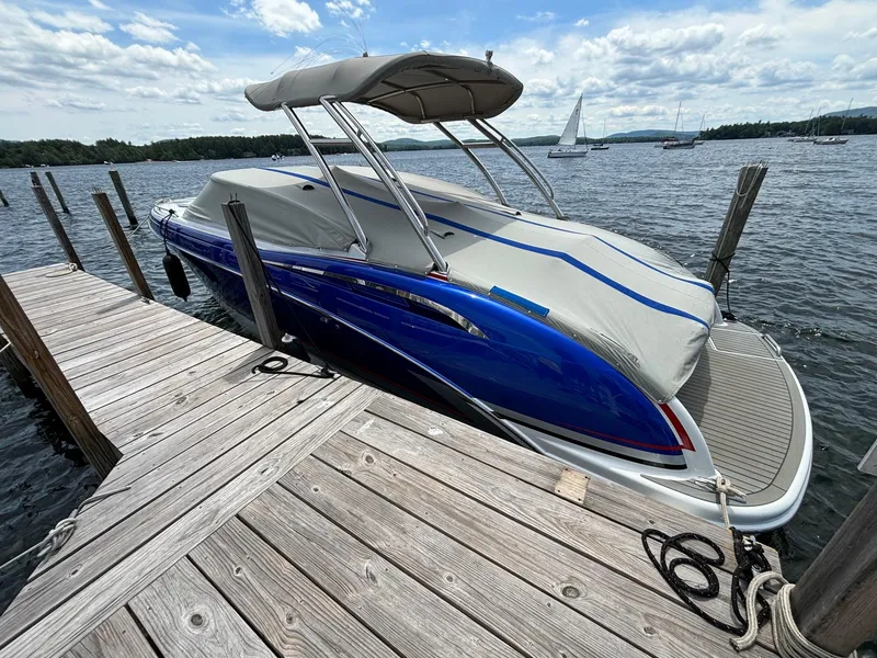 Slide: The Image of 2014 Formula 310 FX5 boat docked on a lake with a covered canopy. - 15