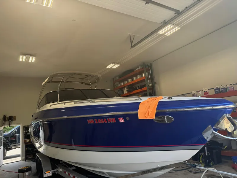 Slide: The Image of 2014 Formula 310 FX5 boat in garage, blue hull, orange cloth on bow. - 16