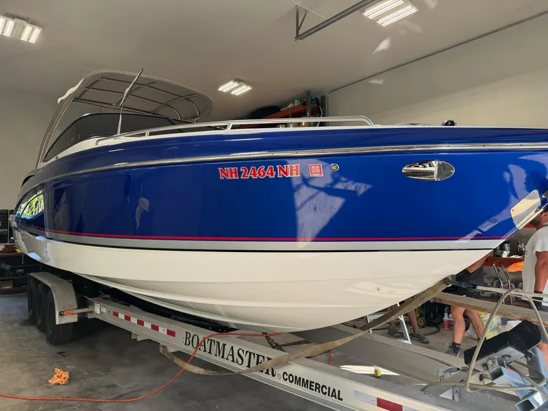 Slide: The Image of 2014 Formula 310 FX5 boat on trailer in garage setting. - 19