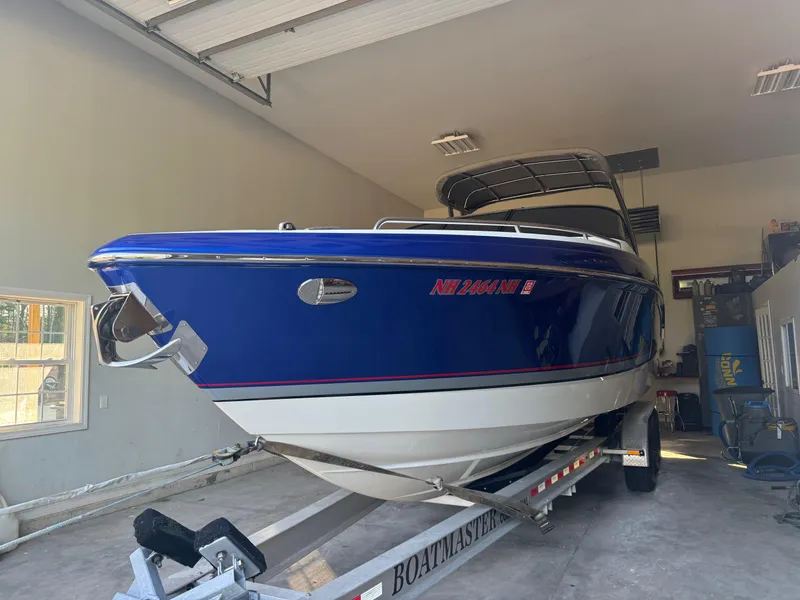 Slide: The Image of 2014 Formula 310 FX5 boat in garage on trailer, blue and white hull. - 20