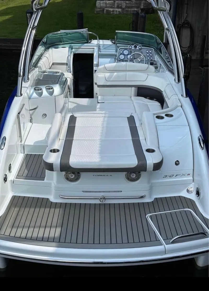 Slide: The Image of 2014 Formula 310 FX5 boat with sleek design and spacious deck layout. - 3
