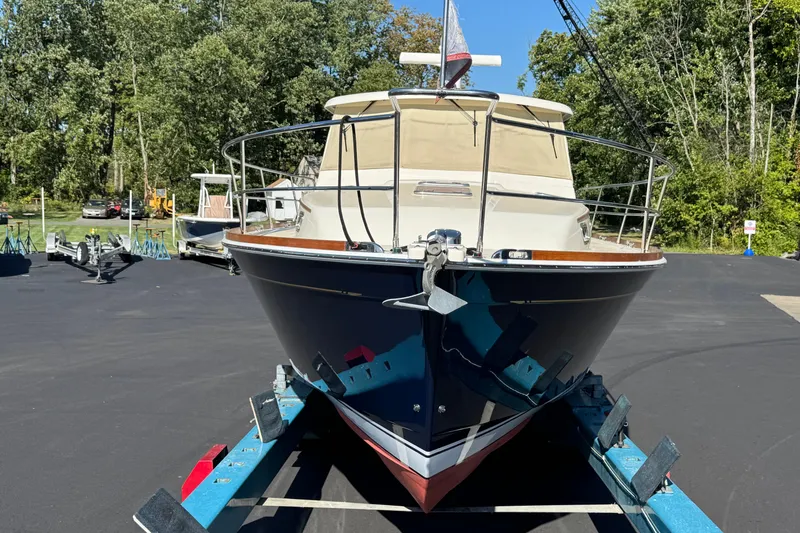 Slide: The Image of 2008 Sabre 38 Hardtop Express boat on trailer, surrounded by trees and parked vehicles. - 12