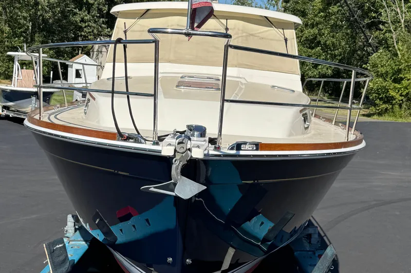 Slide: The Image of 2008 Sabre 38 Hardtop Express boat on trailer, surrounded by trees. - 13