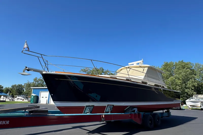 Slide: The Image of 2008 Sabre 38 Hardtop Express boat on trailer under clear blue sky. - 16
