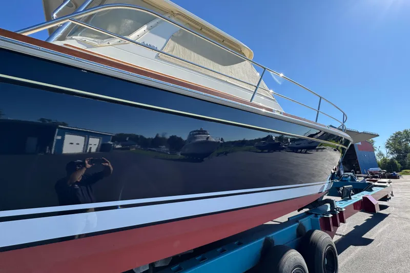 Slide: The Image of 2008 Sabre 38 Hardtop Express boat on trailer under clear blue sky. - 2