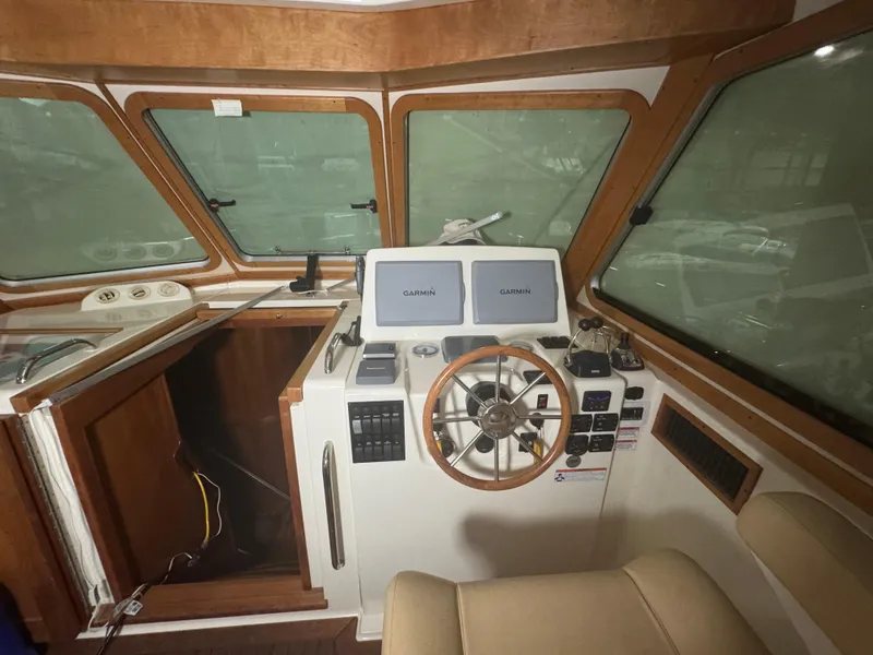 Slide: The Image of 2008 Sabre 38 Hardtop Express helm with Garmin displays and wooden steering wheel. - 20