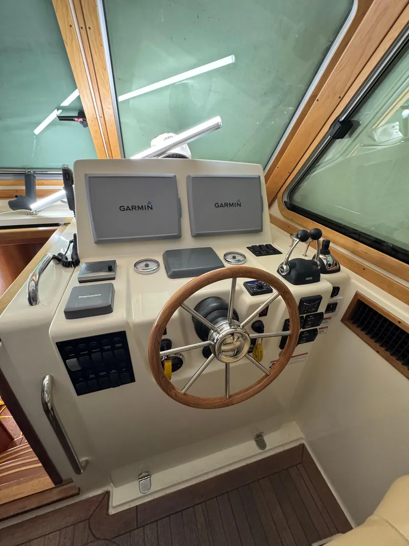 Slide: The Image of 2008 Sabre 38 Hardtop Express helm with Garmin navigation displays and wooden steering wheel. - 21