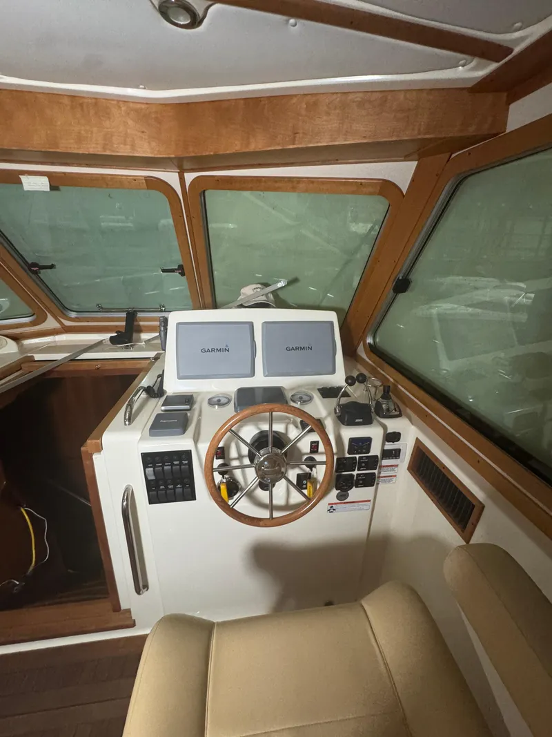 Slide: The Image of 2008 Sabre 38 Hardtop Express helm with Garmin navigation displays and wooden steering wheel. - 22