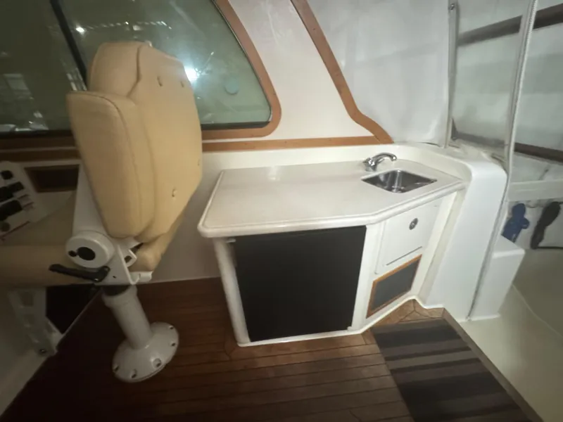 Slide: The Image of Interior of 2008 Sabre 38 Hardtop Express with helm seat and compact sink area. - 24