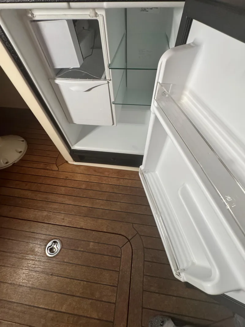 Slide: The Image of Open refrigerator on 2008 Sabre 38 Hardtop Express, showcasing wooden flooring and interior shelves. - 26