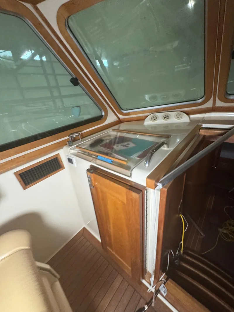 Slide: The Image of 2008 Sabre 38 Hardtop Express interior with wooden cabinetry and large windows. - 29