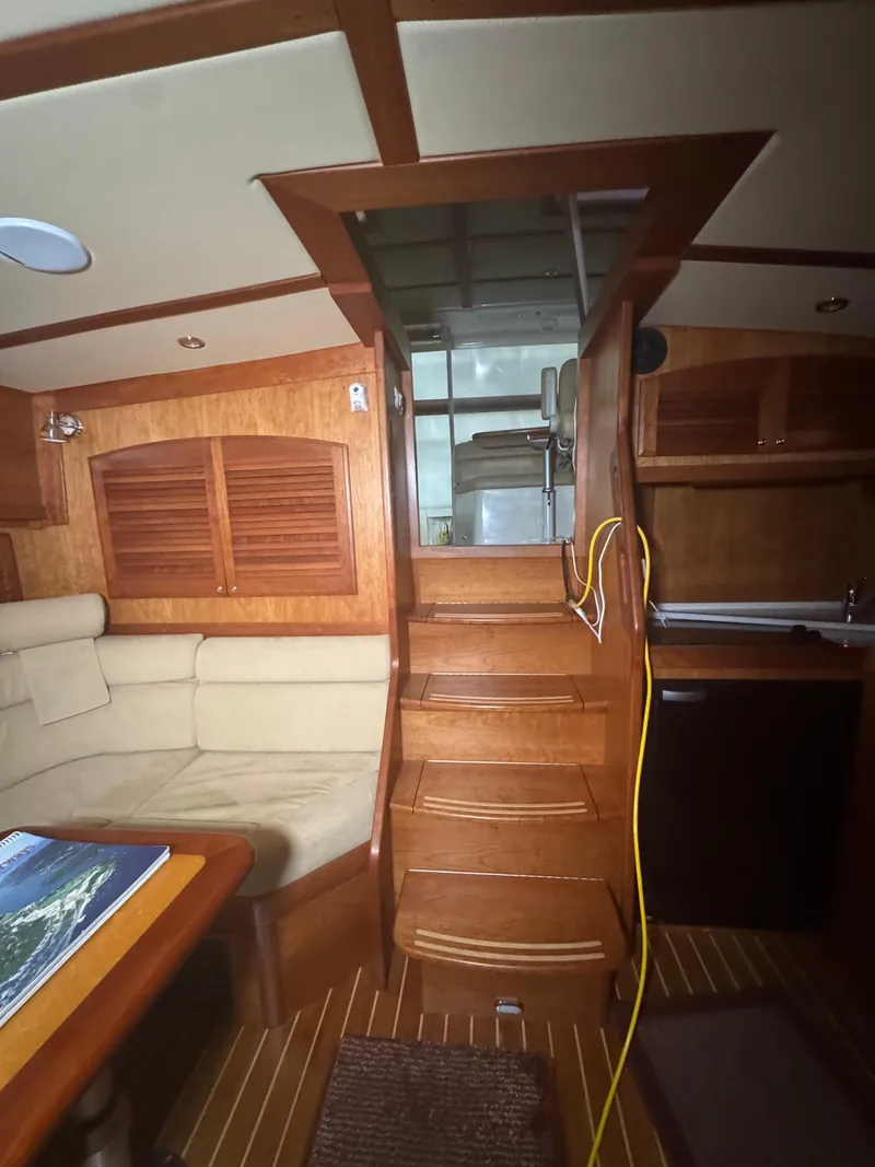 Slide: The Image of Interior of 2008 Sabre 38 Hardtop Express, featuring wooden stairs and cozy seating area. - 32