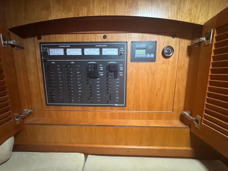 Slide: The Image of Electrical control panel inside 2008 Sabre 38 Hardtop Express boat, featuring switches and gauges. - 38