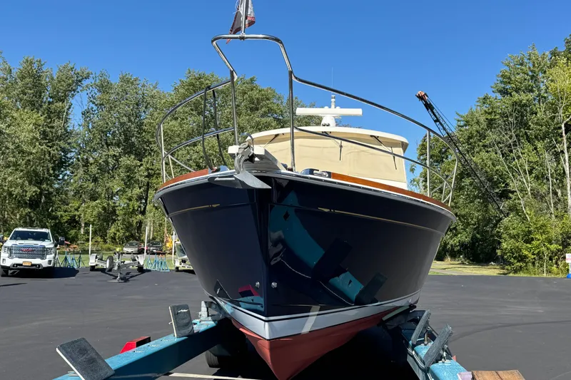 Slide: The Image of 2008 Sabre 38 Hardtop Express boat on trailer, surrounded by trees and vehicles. - 4