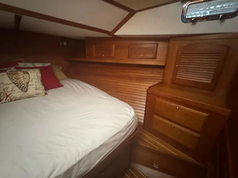 Slide: The Image of 2008 Sabre 38 Hardtop Express cabin with wooden interior and cozy bedding. - 43