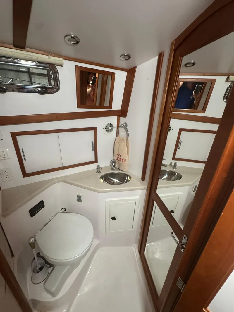 Slide: The Image of 2008 Sabre 38 Hardtop Express bathroom with sink, toilet, and wooden accents. - 47