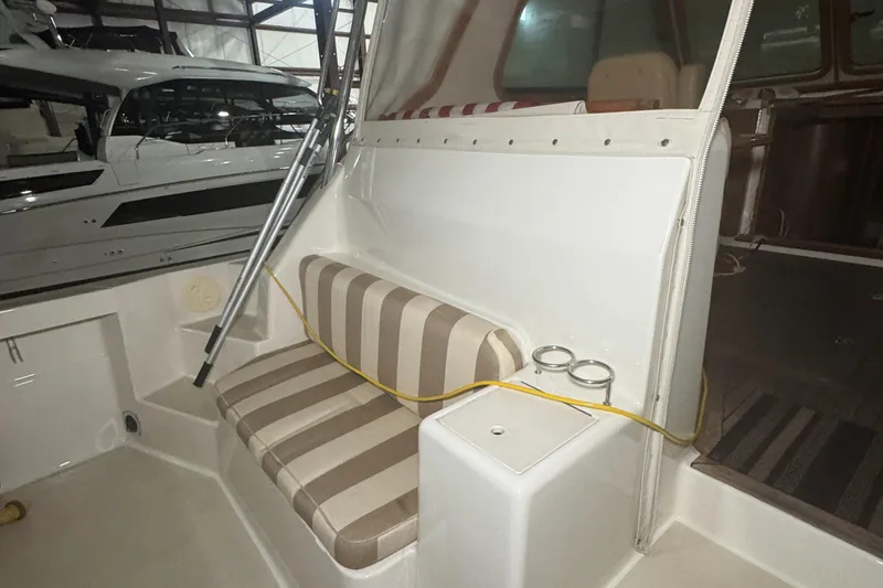 Slide: The Image of 2008 Sabre 38 Hardtop Express interior with striped seating and cup holders. - 48